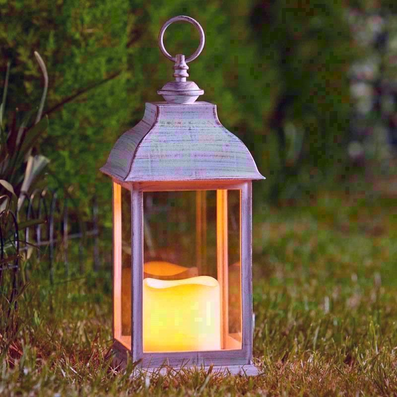 A garden lantern on a grass lawn