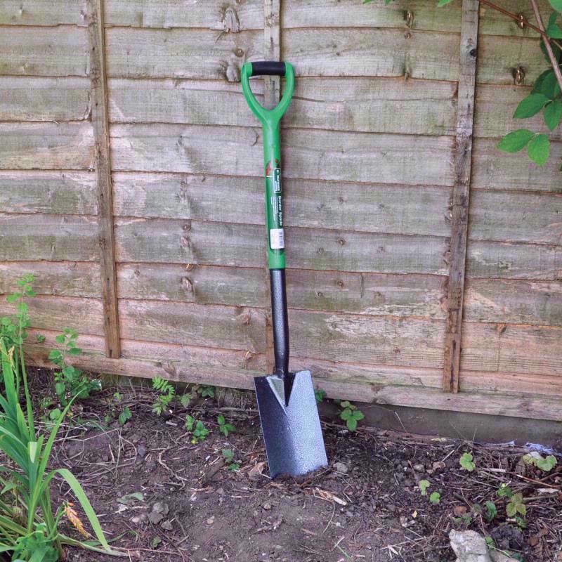 A Kingfisher Border Spade against a garden fence